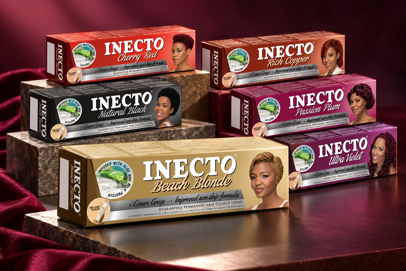 Inecto Colours hair-colour cartons arranged as a studio product group showing the original shade-specific packaging