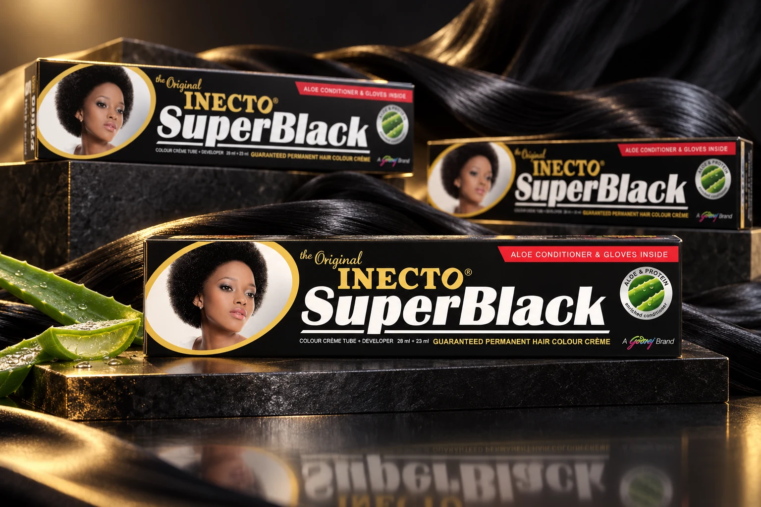 Inecto SuperBlack cartons with the original black, gold and white identity arranged with black satin and aloe on dark studio plinths